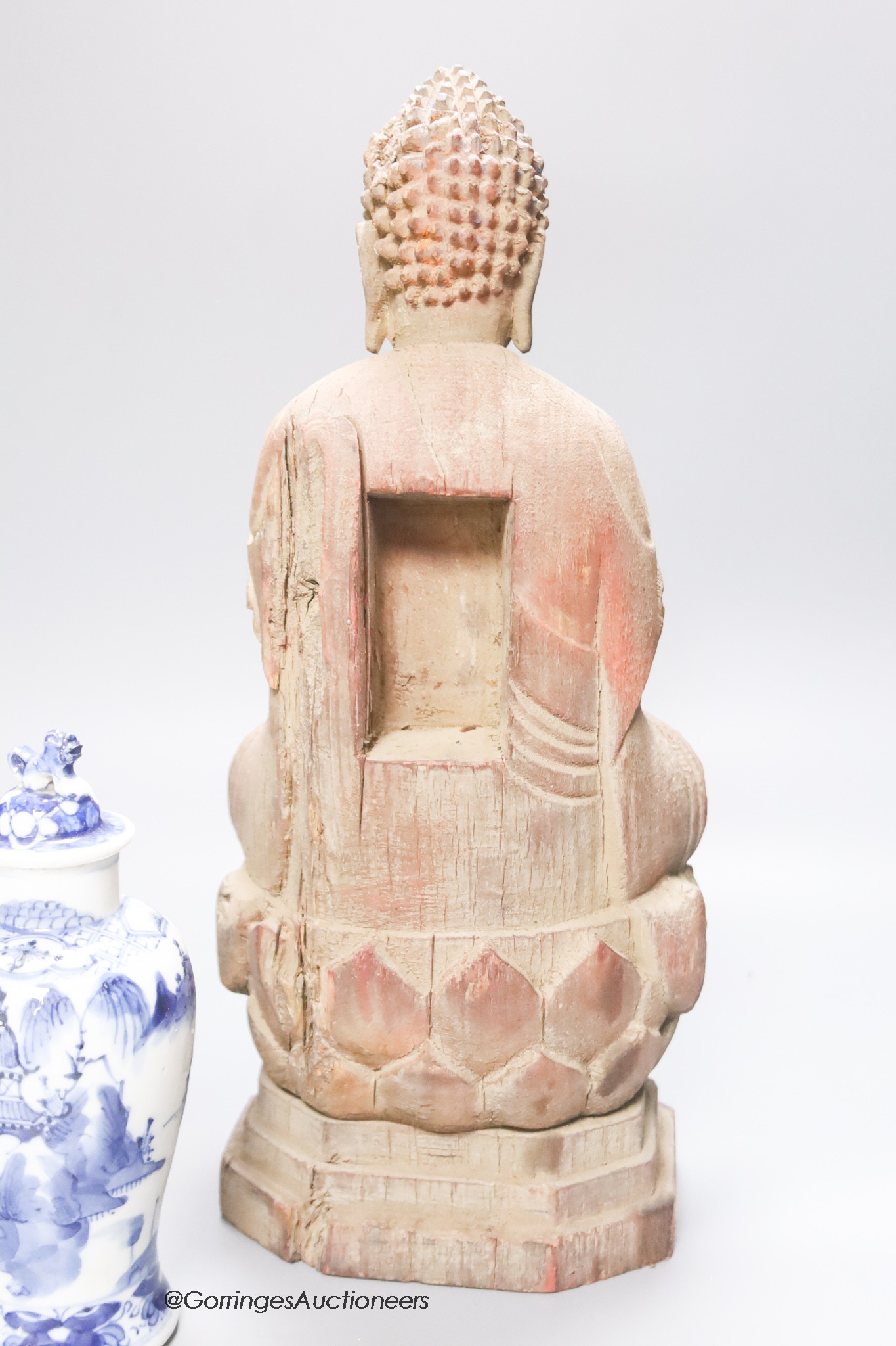 A 20th century carved wooden Buddha, height 34cm, a 19th century Chinese blue and white lidded vase, and a famille rose bowl and cover